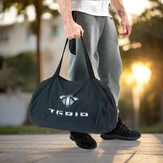 Man holding a TGrip bag of resistance bands for an outdoor workout.